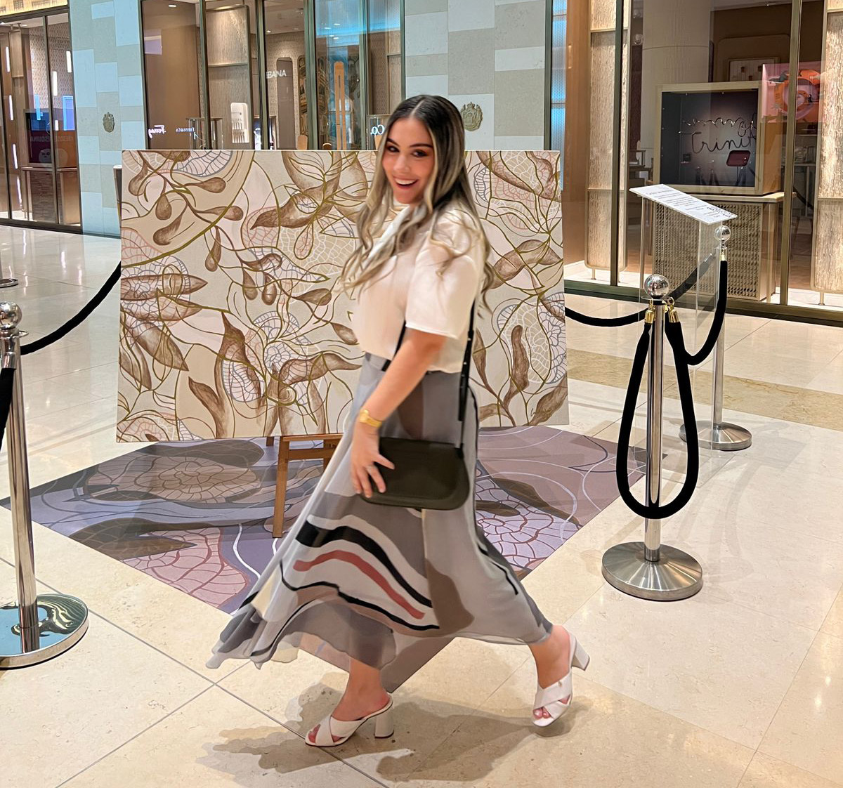 Carolina Jaen smiling with 3 of her works